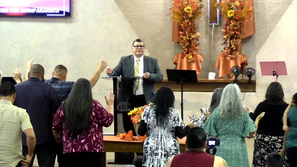 Pastor John Martinez leading worship with the New Beginnings congregation